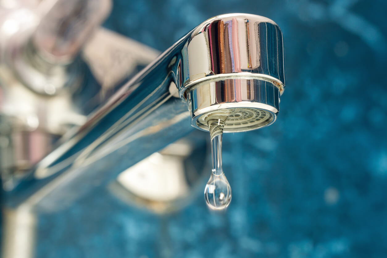 Closeup of faucet dripping water